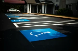 Proper line striping in commercial company parking lot showing ada compliant parking spaces